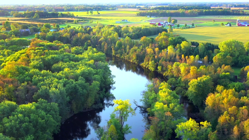 Flying over Autumn colors by the Oconto River, rural Wisconsin, aerial view.
