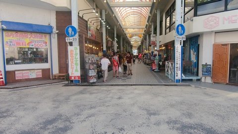 Ishigaki , Okinawa / Japan - 09 01 2019: Tilt Up Shot of tourists shopping for souvenirs in Euglena Mall. Ishigaki Island, Okinawa, Japan. Circa September 2019.