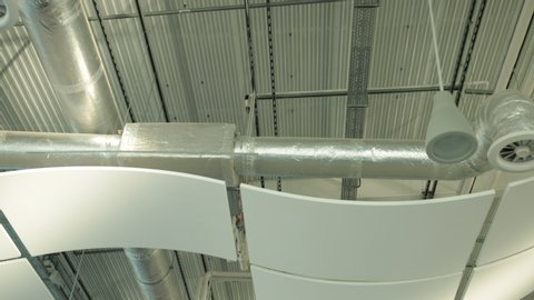 air duct ventilation pipes on ceiling of big industrial building