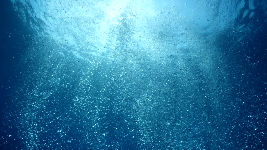 bubbles slow motion underwater coming up to surface with sun beams scenery dark blue backgrounds Royalty-Free Stock Footage #1038206414