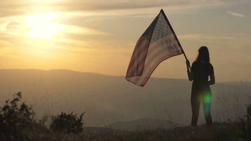 Patriot with American flag on top of a mountain Royalty-Free Stock Footage #1038209171