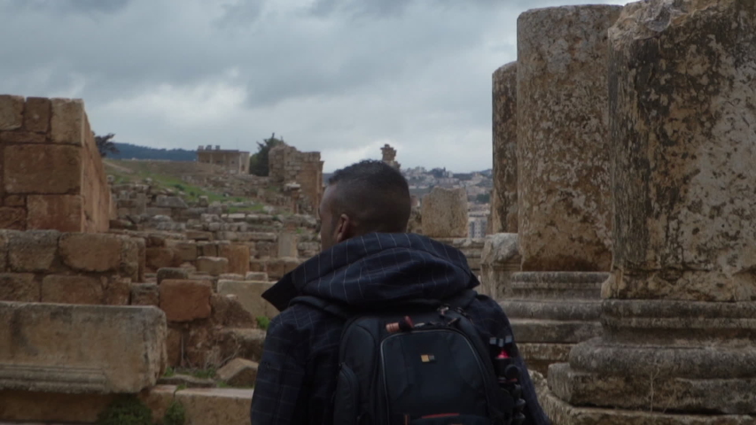 photographer walking on ancient Roman ruins