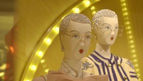 Women's clothing store. Mannequins dressed in stylish luxury clothes in shop-window on beautiful yellow illuminated background. Merchandising, consumerism and fashion retail industry concept. - Powered by Shutterstock - Get 15% off with code: PIKWIZARD15