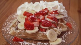 waffle with whipped cream strawberries and banana, sweet delicious dessert