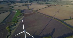 Aerial drone footage of wind turbine and shadow