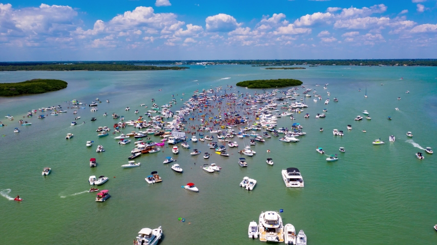 Aerial time lapse of boats surrounding annual sand bar party near John