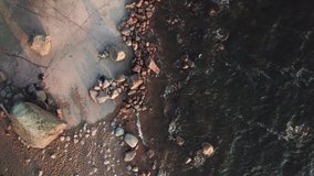 4K summer late afternoon aerial video of Baltic Sea Gulf of Finland lagoon, pine tree wild unspoiled forest beach with red granite boulders and rocks, lone island beach in northern Europe