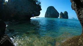 UltraHD video - Big. limestone rock formations standing in the warm. shallow water of the tropical sea on a clear. sunny day.