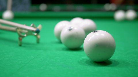 billiards. Close-up. man hand with cue and white ball on a green pool table. copy space