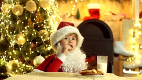 Little Santa child picking cookie and glass of milk at home. Santa - funny child picking cookie. Santa boy child eating cookies and drinking milk - Powered by Shutterstock - Get 15% off with code: PIKWIZARD15