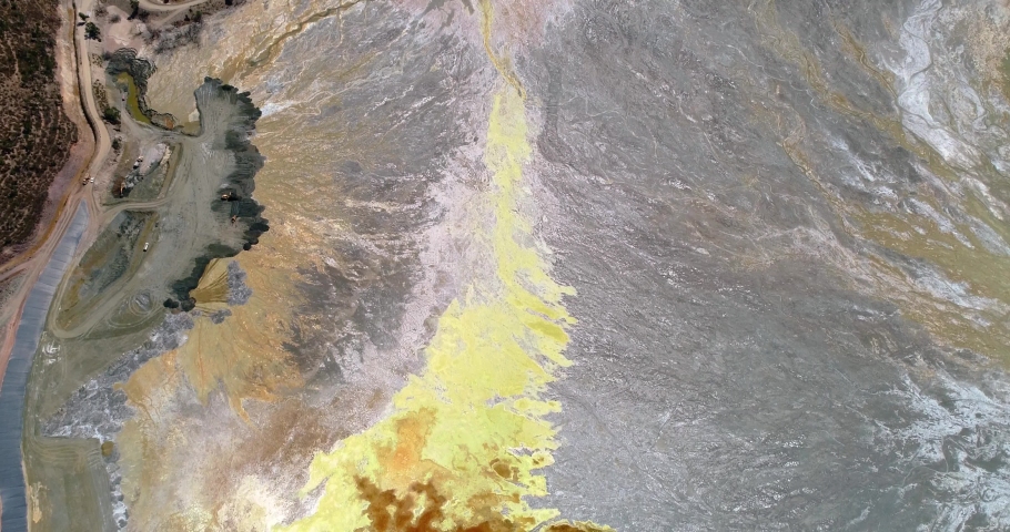 Aerial view of an open pit. Open pit mine with trucks, rock or ore mining