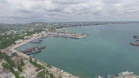 Aerial video of the Genoese fortress of Caffa in Fiodosia, Crimea in summer, view of the port, buildings.