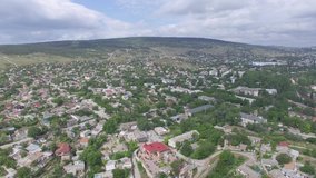 Aerial video of the Genoese fortress of Caffa in Fiodosia, Crimea in summer, view of the port, buildings.