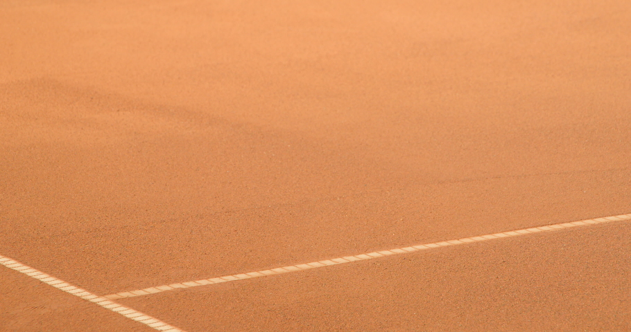 A Tennis Player slides across a clay tennis court and plays the shot in slow motion. Royalty-Free Stock Footage #1038238289