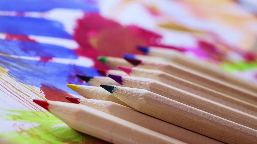Group of sharp multicolored pencils on colored background ,racking focus 