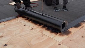 Bitumen roofing.  Roofing with a gas burner and a roll of tar paper. Flat roof installation. 