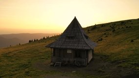 Aerial drone footage of Lucaciasa mountain shelter, in Maramures Mountains at a height of 1635m, a picturesque alpine hut made entirely from pinewood by local craftsmen, keeping alive the traditional 