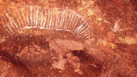 Uluru, Northern Territory, Australia - Aug 23, 2019: Aboriginal art along Kuniya walk, a popular walk at base of Ayers Rock, Uluru-Kata Tjuta NP. Red Centre outback.