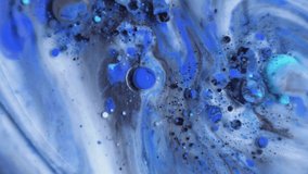 Slow moving blue universe. Abstract milk and oil experiment.