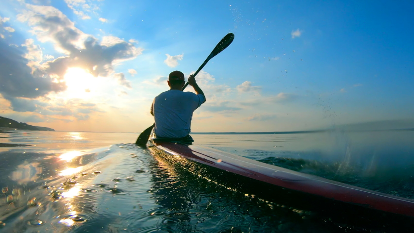 Backside view of a male boater navigating a canoe Royalty-Free Stock Footage #1038280754