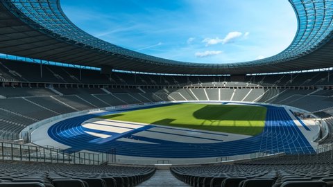 BERLIN, GERMANY - September 2019: timelapse of the Olympiastadion, olympic stadium in Berlin from the inside with a nice blue sky and clouds passing by