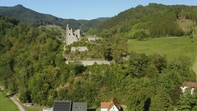 Aerial view of the castle Schenkenburg close to Schenkenzell in Germany in the black forest on a sunny day in summer. Pan to the right around the castle.