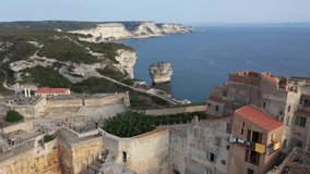 Aerial video of Bonifacio port in South of Corsica. Harbour. Limestone cliffs. Fortress.