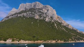 Aerial video of Isola di Tavolara in Emerald Coast of Sardinia. Tavolara is the second biggest rock in the World. It is a 5km long and 1 km wide limestone in the Mediterranean Sea.  