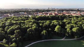 Munich city skyline and Englischer Garten, a large public park in central Munich, Germany. Drone video, aerial view