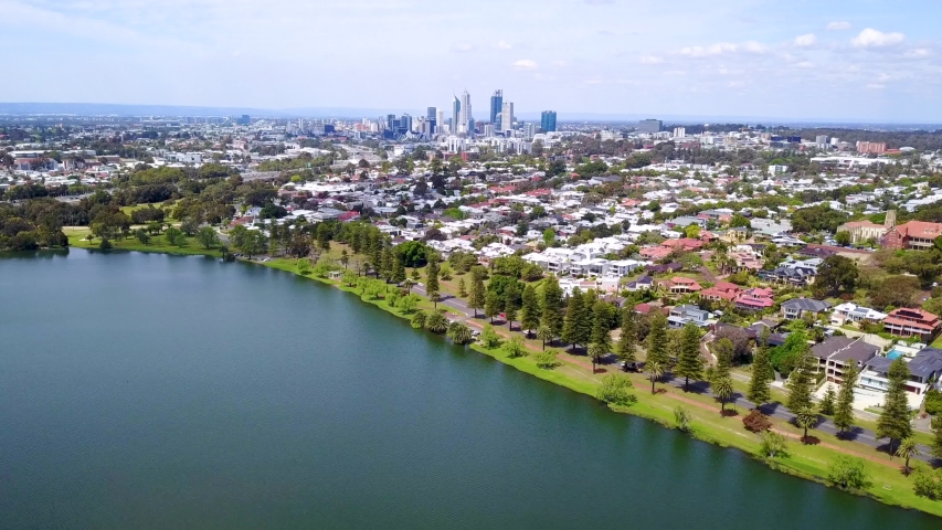 Drone footage over Lake Monger in Perth, Western Australia, including the Perth City skyline. Perth, Western Australia, Australia. Royalty-Free Stock Footage #1038296036