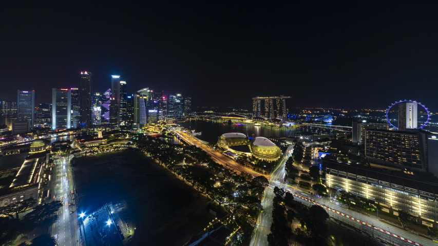 Beautiful clear Singapore aerial time lapse of CBD city skyline and busy light trails at night. Full HD.