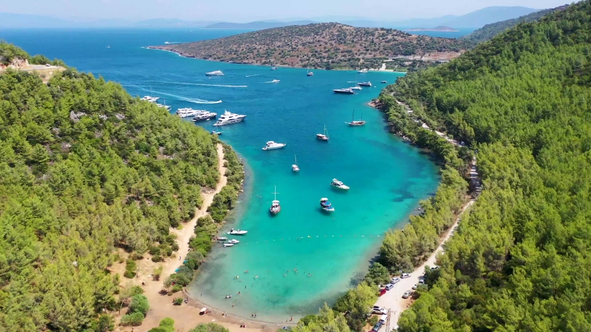 yachts anchored at a green and turquoise-colored Mediterranean coast, zooming in, drone footage Royalty-Free Stock Footage #1038303734