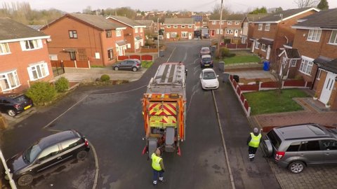 Stoke on Trent , Staffordshire / United Kingdom (UK) - 02 14 2019: Aerial View of Dustmen putting recycling waste into a waste truck, Bin Men, Recycling day, refuse collection in Stoke on Trent,