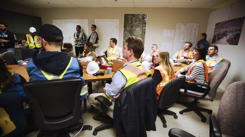 Calgary / Canada - 02 14 2019: Group of construction workers gathering in a job site board room.