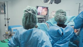 Laparoscopic surgical operation transmitted on hospital video monitors being performed 4K 