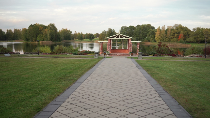 Green bench by the pond in autumn