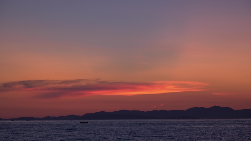 Twilight on the Adriatic Sea. Silhouettes of boats floating on the sea.
