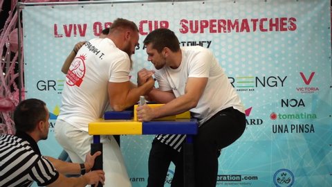 LVIV, UKRAINE - SEPTEMBER 29, 2019: Participants of a tournament on Arm wrestling «Lviv Open Cup Supermatches». Slow motion.