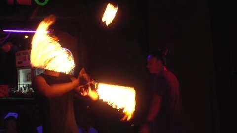 Thailand, Phi Phi Island, September 28, 2019: Fire show on the open beach. firespinner rotates burning torches in a circle