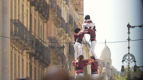 Barcelona, Spain. September 24th 2019: 
Castellers. Human Towers performance in Sant Jaume Square. Defocused Barcelona architecture on the background. Colla Castellera Jove de Barcelona