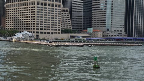 New York / United States - 07 28 2019: Manhattan Helicopters Heliport on East River Pier, View From Moving Boat, Slow Motion