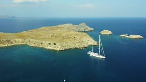 Aerial birds eye view drone video bay on Rhodes island, Dodecanese, Greece. Panorama with nice lagoon and clear blue water. Famous tourist destination in South Europe
