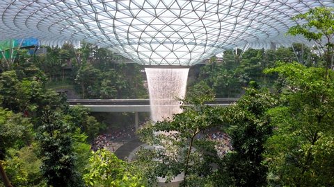 Singapore-August 08, 2019: Crowed tourist at The Most Famous new landmark The Rain Vortex, a 40m-tall indoor waterfall located inside the Jewel Changi Airport in Singapore.