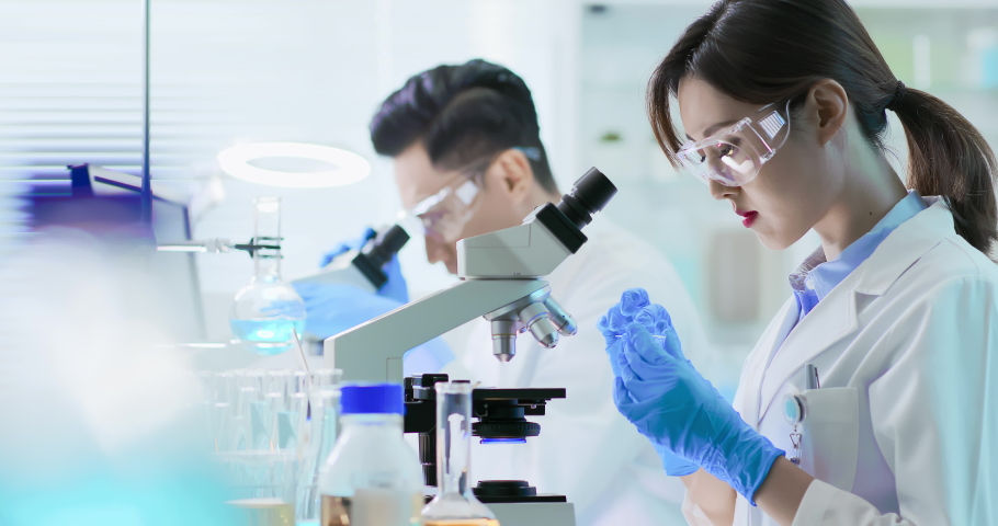 asian scientist team use microscope in the laboratory Royalty-Free Stock Footage #1038347732