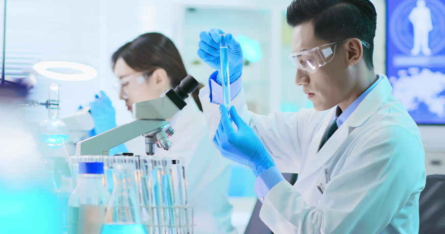 Asian scientist team use microscope in the laboratory | Shutterstock HD Video #1038347735
