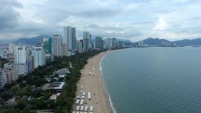 Aerial video footage of popular tourist destination of Nha Trang on the South Central Coast of Vietnam panning from the beach to the sea and to coastal islands