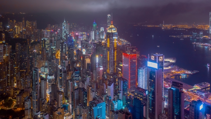 Hong Kong, China 8 July 2019:Aerial drone hyper lapse or time lapse over Hong Kong at night. Central distinct of Hong Kong shot by 4K resolution drone, Victoria Harbor, Hong Kong financial center.
