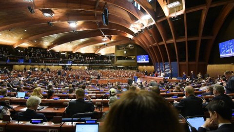 Strasbourg, France - Oct 1 2019: Panning wide angle of Coe Hemicycle with President of the French Republic Emmanuel Macron address to the Parliamentary Assembly of the Council of Europe with speech