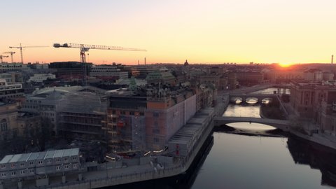 Aerial drone shot of Stockholm city and construction site at sunrise