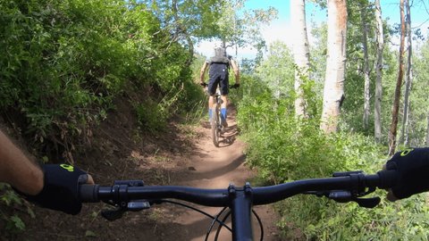 Point-of-view, P.O.V of mountain bikers on the Mid-Mountain single-track mountain bike trail in canyons village, Park City, Utah, Wasatch Mountains.  Go Pro footage shot in UHD.
 ஸ்டாக் வீடியோ